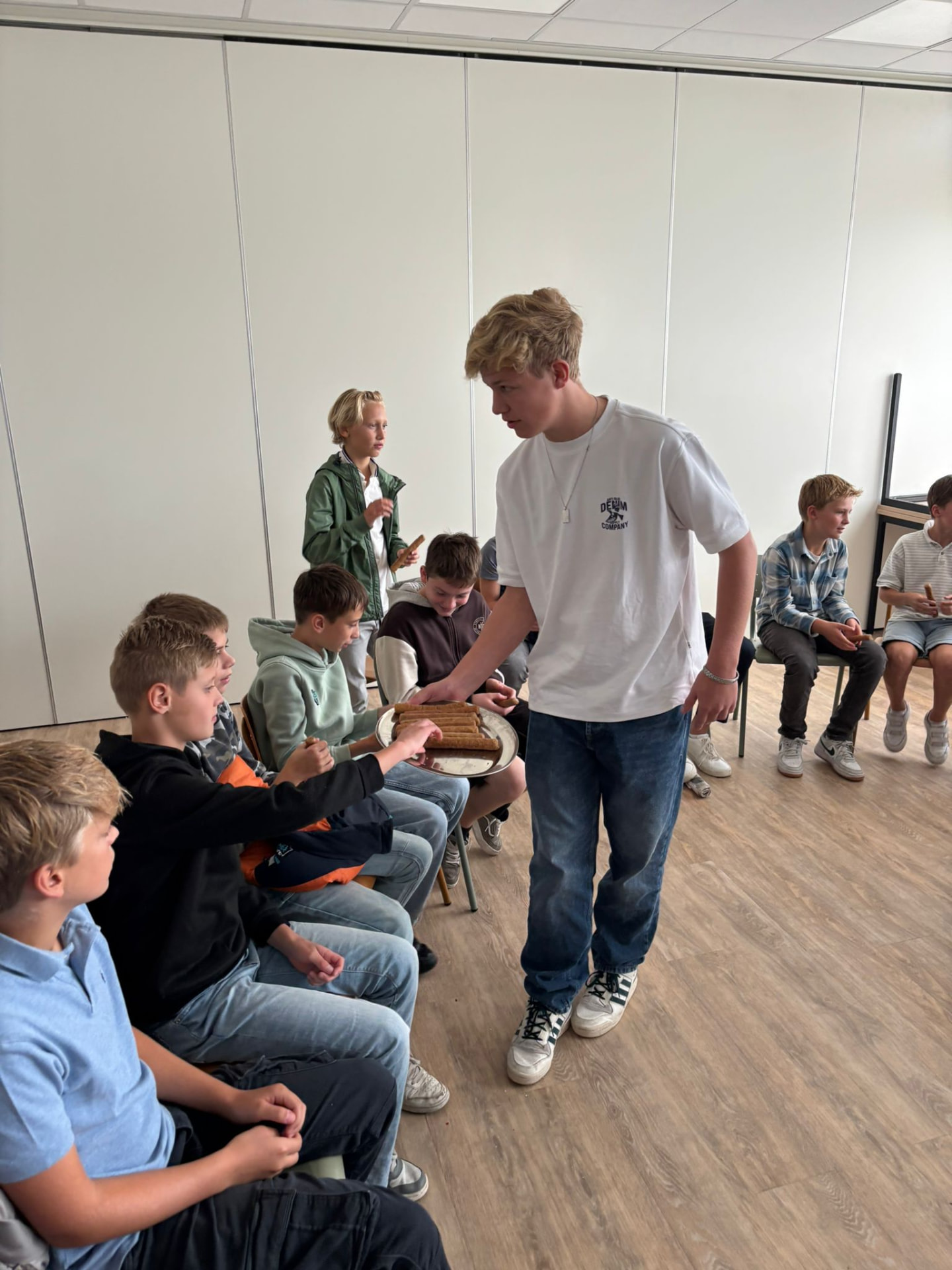 Jorik van afdeling B deelt frikandellen uit aan de nieuwste knapen, september 2025